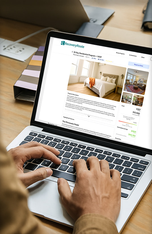 A person using a laptop displaying the RecoveryRoute website.